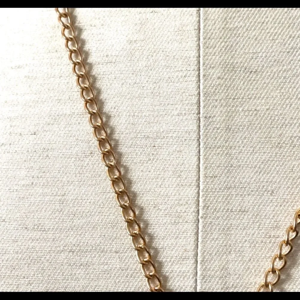 Gold tone long tassel necklace